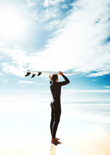 istock surfer walking in surfers paradise beach in australia 828412480