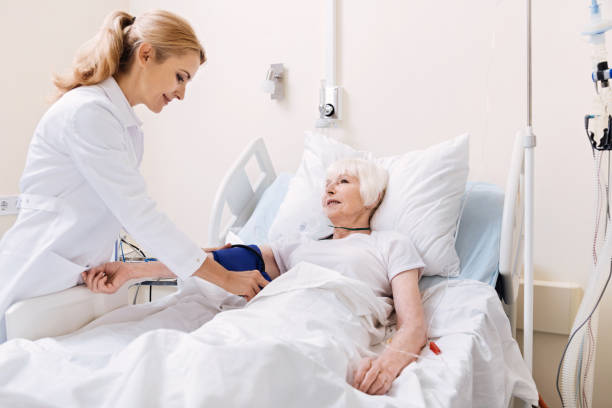 istock Committed clever doctor measuring blood pressure 828419792
