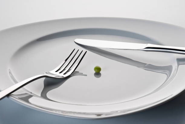 Plate with cutlery and a pea stock photo