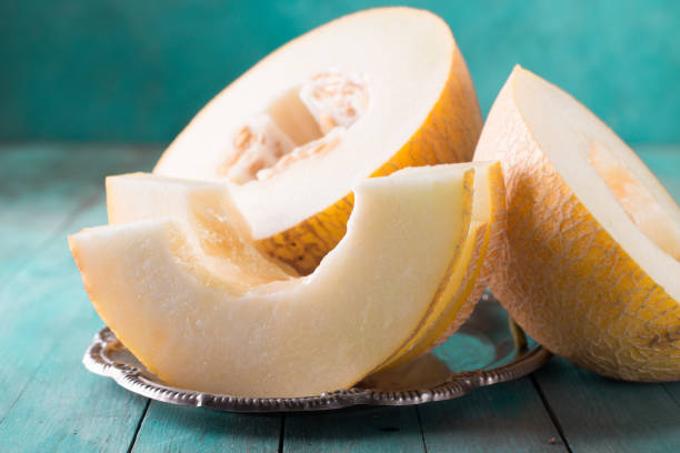 istock Fresh sweet orange melon on the wooden table, selective focus and toned image 828421432