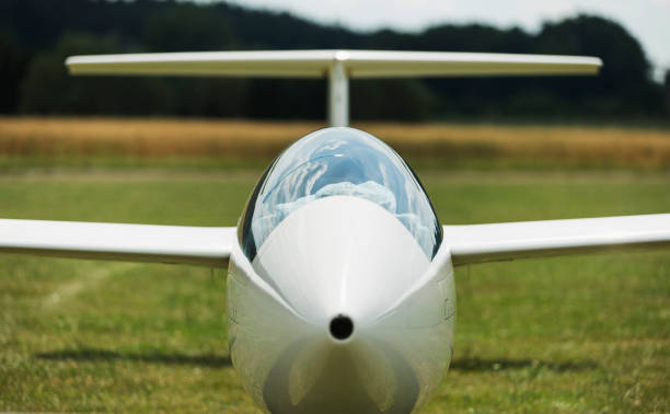 A young woman is learing how to fly a glider.