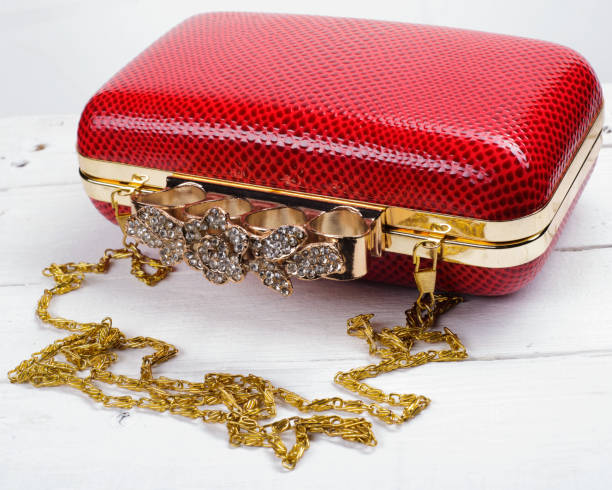 istock Red handbag clutch with chain on white background 828433108