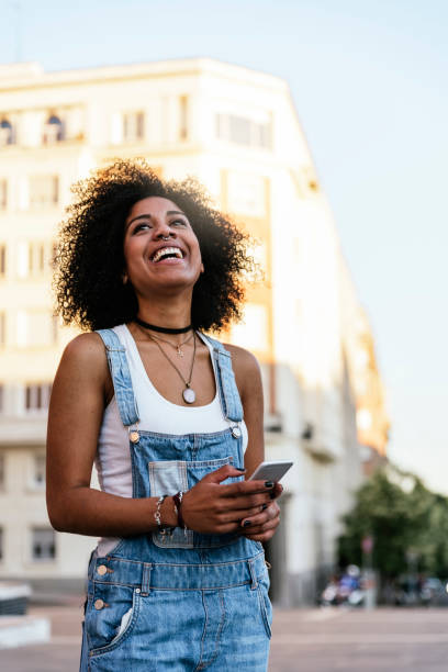 istock Beautiful woman using mobile in the Street. 828433294