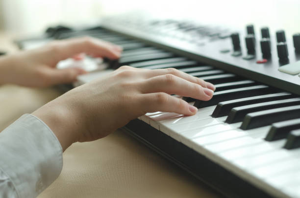 istock Female are playing on the synthesizer 828436718