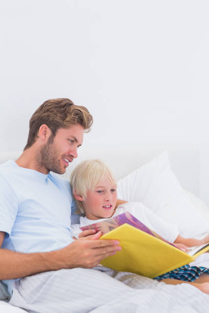 istock Father reading a story to his cute son 828436898