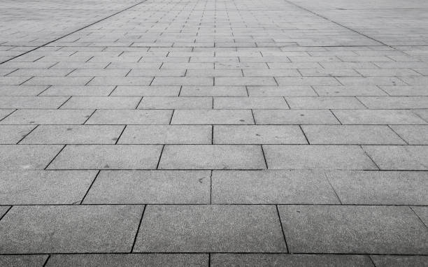 Perspective View of Monotone Gray Brick Stone on The Ground for Street Road. Sidewalk, Driveway, Pavers, Pavement in Vintage Design Flooring Square Pattern Texture Background stock photo
