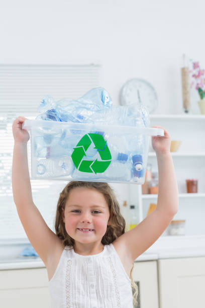 istock Girl holding crate with plastics on her head 828437096