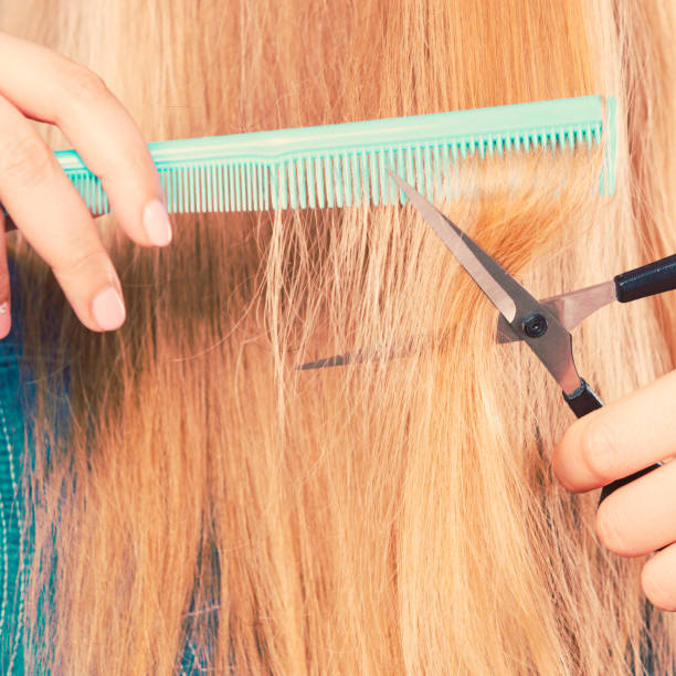 istock Woman cutting down smoothy hair. 828437220