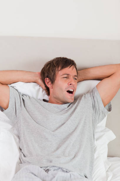 istock Portrait of a man yawning 828437516