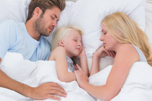 istock Beautiful family sleeping together 828437682