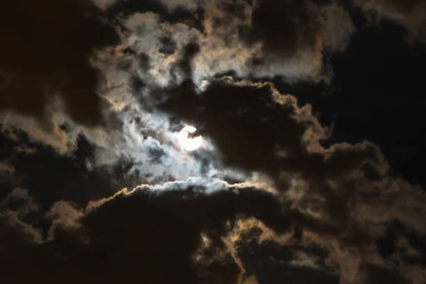 istock the moon coming through the clouds 828440602