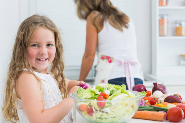 istock Girl preparing vegetable salad 828441008