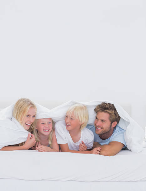 istock Cheerful family under the duvet 828441028