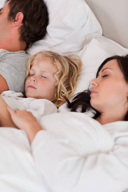 istock Portrait of a boy sleeping between his parents 828441246