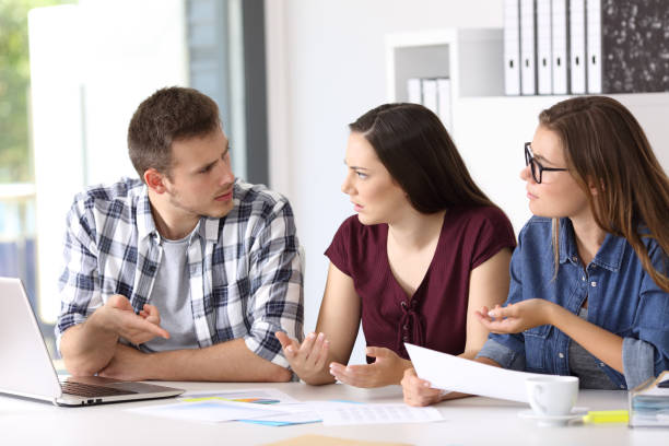 istock Employees having a job conversation at office 828443720