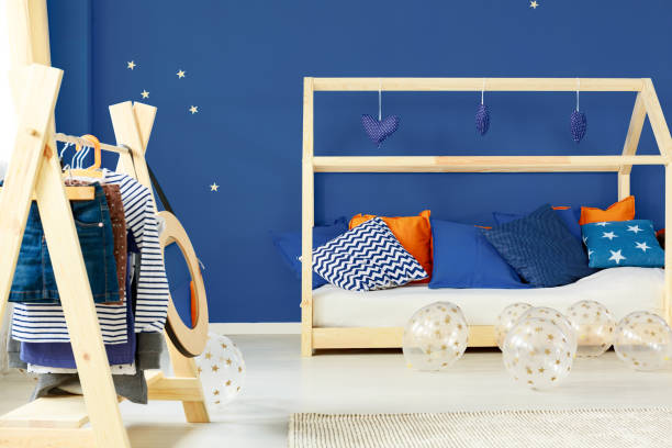 istock Coat rack and bed in room 828443938