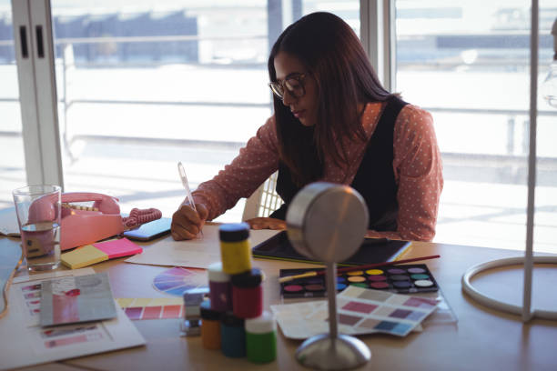istock businesswoman writing on paper at creative office 828444800