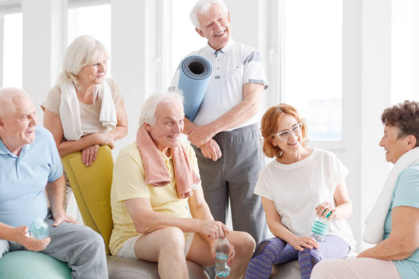 old people talking - fun senior adult aerobics exercise class imagens e fotografias de stock
