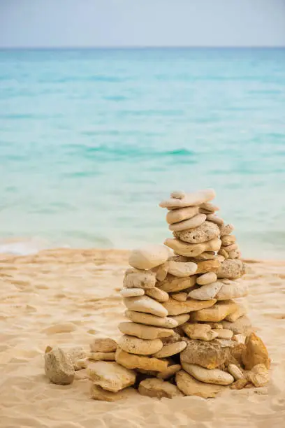 Photo of Balance stone on sea coast. Zen rocks on the beach. Feng Shui balance