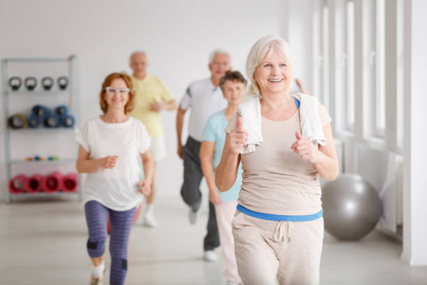 seniors exercising together - fun senior adult aerobics exercise class imagens e fotografias de stock