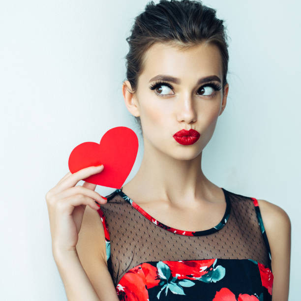 istock Beautiful woman holding artificial heart 828449368