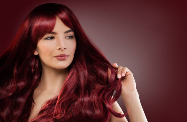 Fashion Model Woman with Mahogany Red Hairstyle. Redhead Girl on Background with Copyspace