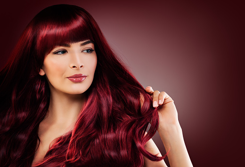 Fashion Portrait of Beautiful Woman with Long Healthy Hairstyle. Perfect Model with Red Hair