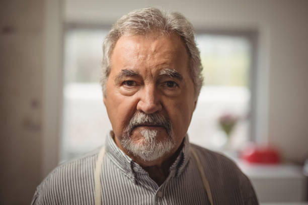 istock Confident senior man standing in home 828452446