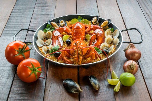 istock Paella with fresh lobster, clams, mussels and lime 828452644