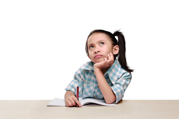 portrait asian little girl holding pen and thinking - child thinking writing little girls imagens e fotografias de stock