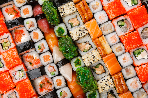 Sushi and rolls pattern background, japanese restaurant delivery top view. Salmon, unagi, california and other healthy meals