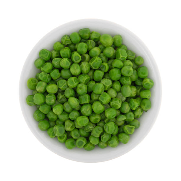 istock Green peas in a white bowl on a white background 828460880