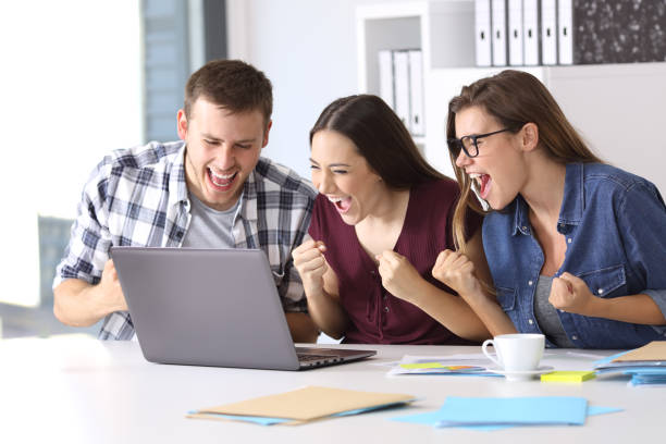 istock Excited employees reading good news at office 828461508
