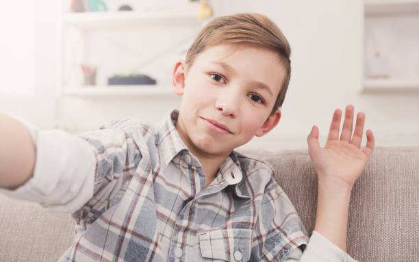 istock Male child taking selfie on phone at home 828464080
