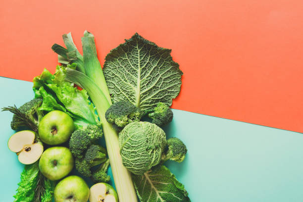 istock Flat lay of green vegetables on bright background 828464364