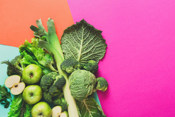 istock Flat lay of green vegetables on bright background 828464486