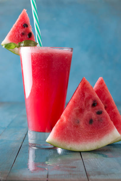 istock Healthy watermelon smoothie on a wood background 828465290
