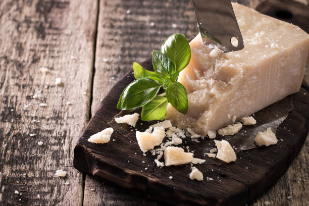 istock Pieces of cheese on wood board on stone background. 828465460