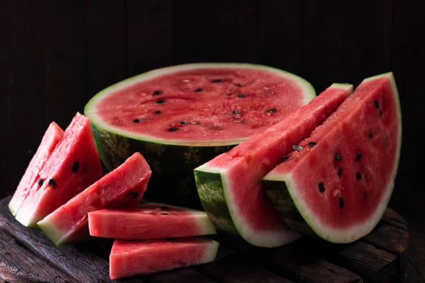 istock watermelon and watermelon pieces in a wooden background. 828468330
