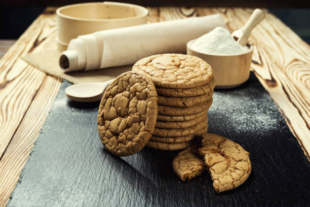 istock Biscuit sweet cookie background. Domestic stacked butter biscuit pattern concept,close up macro.Homemade cookies on wooden table.Cereal biscuits with the sesame,peanuts,sunflower and amaranth. 828468396