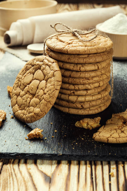 istock Biscuit sweet cookie background. Domestic stacked butter biscuit pattern concept,close up macro.Homemade cookies on wooden table.Cereal biscuits with the sesame,peanuts,sunflower and amaranth. 828468708