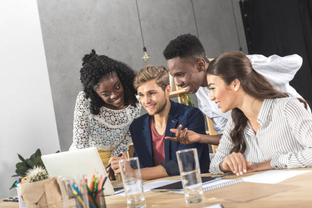 istock business people using laptop together at workplace in office 828468972