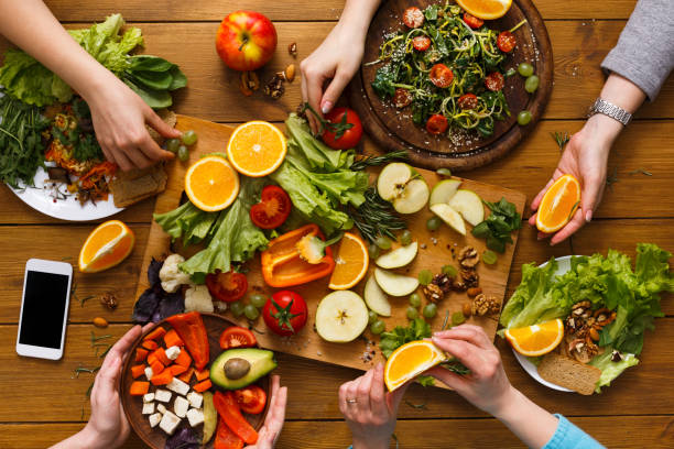 istock Dinner table, women eat healthy food at home kitchen 828469432