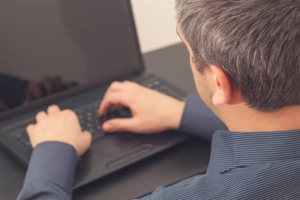 istock Man working on a laptop in the office. 828470328