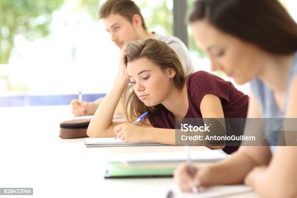 Distracted Student Drawing During A Class Stock Photo - Download Image Now - Classroom, Boredom, Displeased