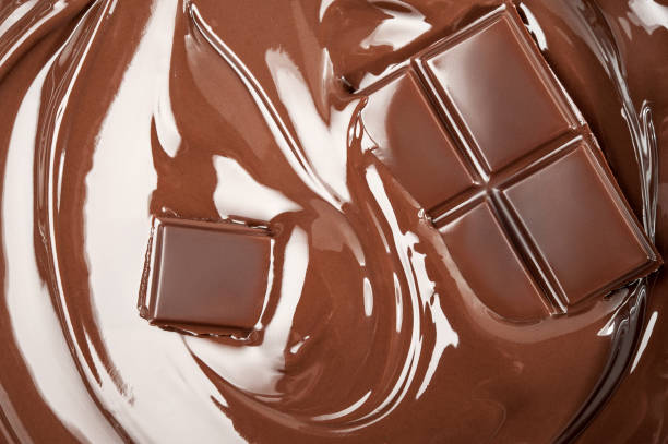 istock Melted pieces of chocolate bar in splash 828476232