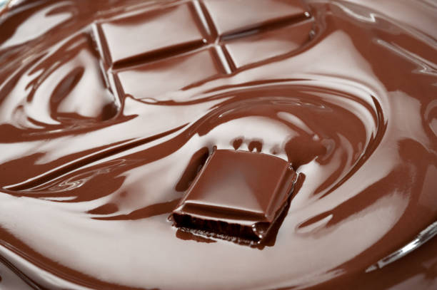 istock Melted pieces of chocolate bar in splash 828476266