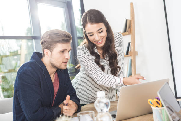 istock business people using laptop while working together in office 828476976