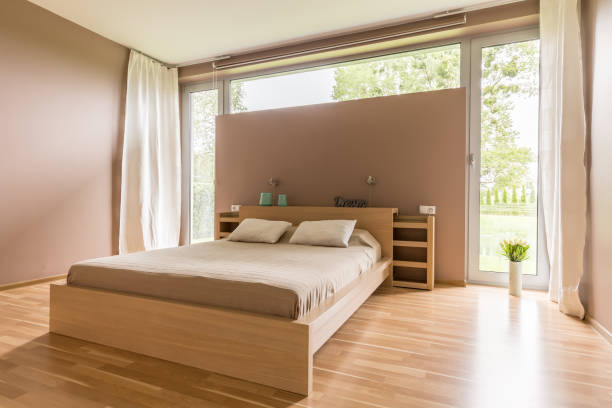 istock Big bed with beige duvet 828479950