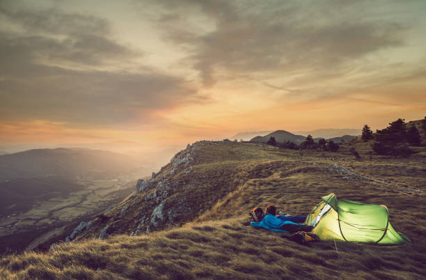istock Young Couple Camping on Top of Hill 828480086